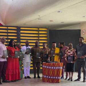 Board Members of National Theatre displaying copies of the document