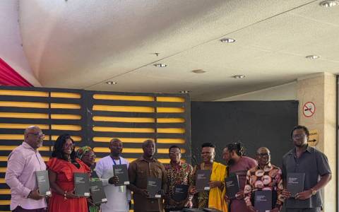 Board Members of National Theatre displaying copies of the document